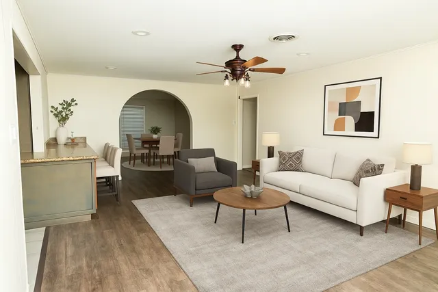a living room with furniture and a wooden floor