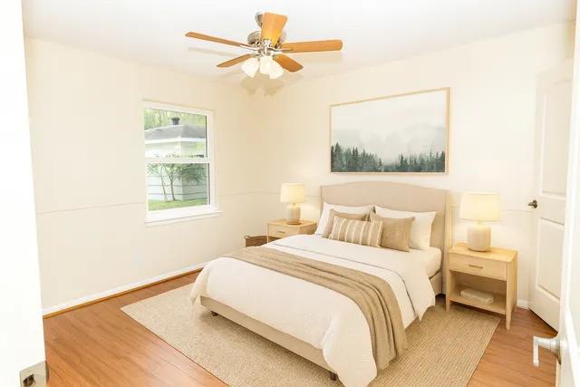 a bedroom with a bed and a window