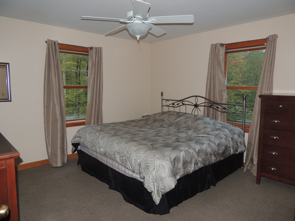 52 Ayers Road Monson, MA 01057 - Photo 12 of 25 a bed sitting in a bedroom next to a window
