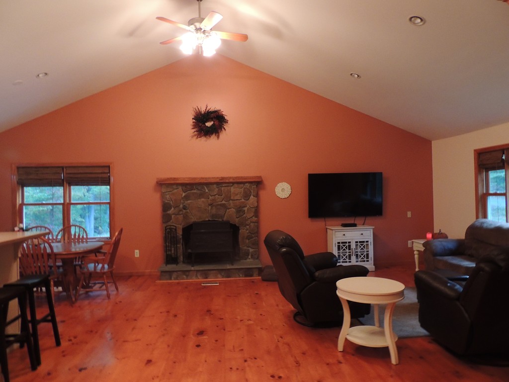 52 Ayers Road Monson, MA 01057 - Photo 8 of 25 a living room with furniture a fireplace and a flat screen tv