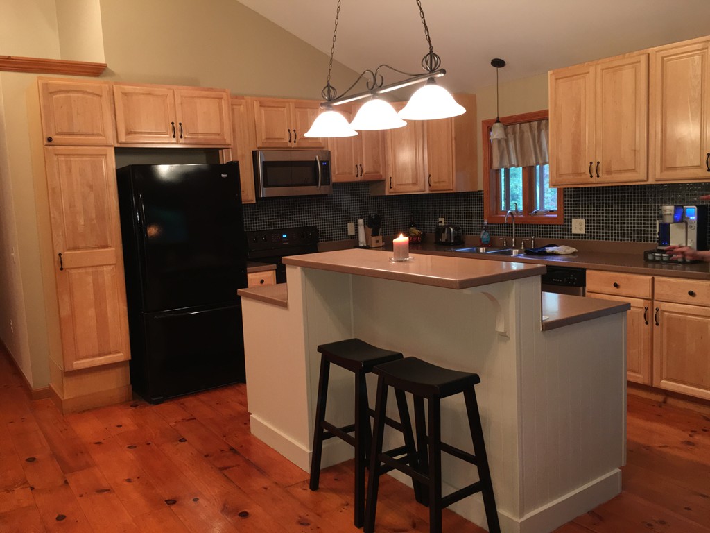 52 Ayers Road Monson, MA 01057 - Photo 10 of 25 a kitchen with stainless steel appliances granite countertop a refrigerator a stove a sink dishwasher and a microwave with wooden floor