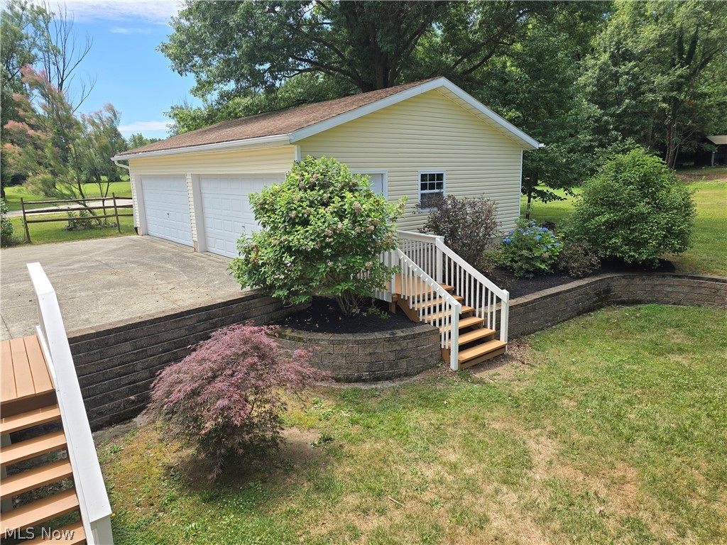 2680 Mayfair Road Akron, OH 44312 - Photo 24 of 25 View of home's exterior featuring a 4 car garage and a lawn