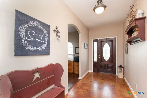 a view of a livingroom with furniture and a painting on the wall