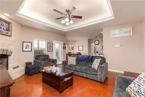 a living room with furniture and a chandelier