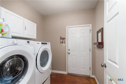 a view of hallway with washer and dryer