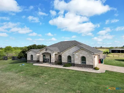 a view of house with backyard