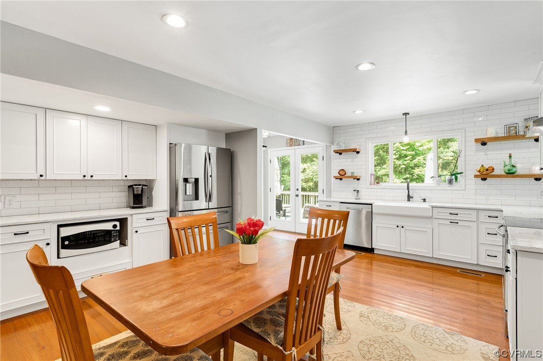 3928 Whitehall Road Sandy Hook, VA 23153 - Photo 11 of 33 a kitchen with stainless steel appliances granite countertop a stove a sink a dining table and chairs