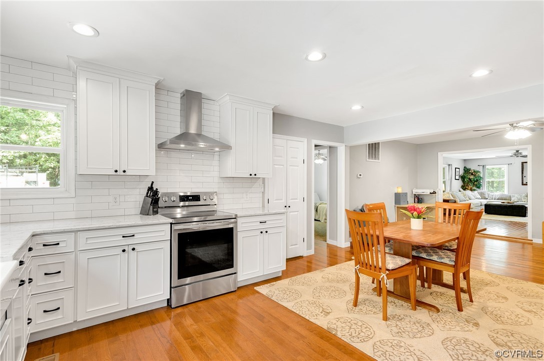 3928 Whitehall Road Sandy Hook, VA 23153 - Photo 13 of 33 a view of a kitchen with a dining table chairs and a stove