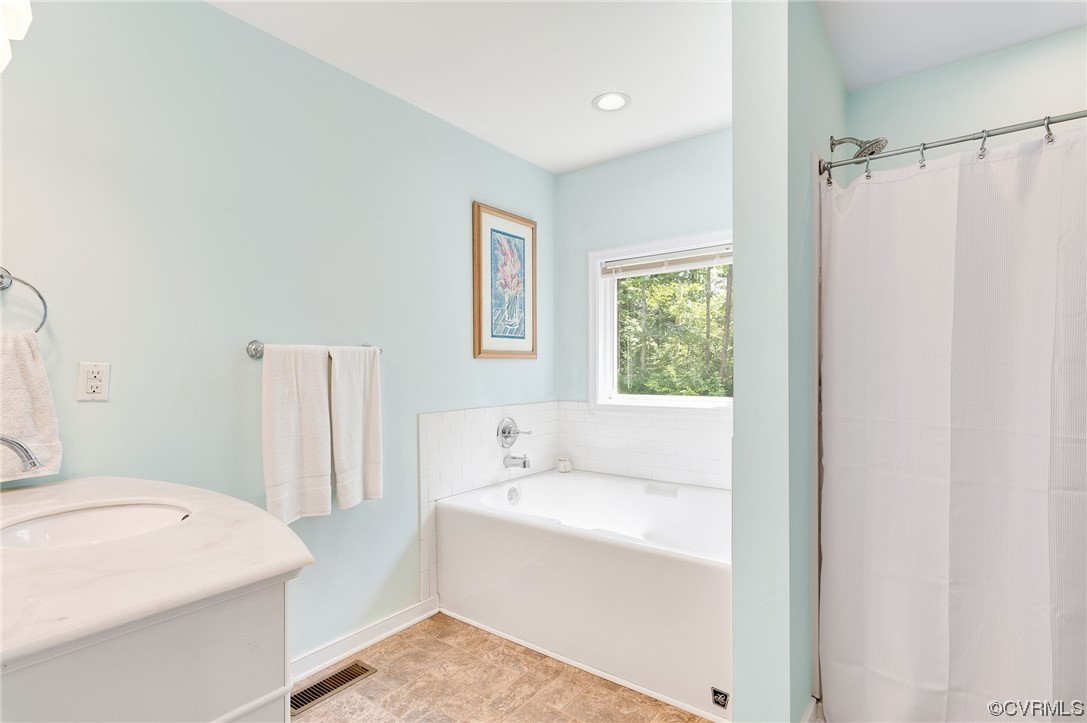 3928 Whitehall Road Sandy Hook, VA 23153 - Photo 18 of 33 a bathroom with a sink a bathtub and a window