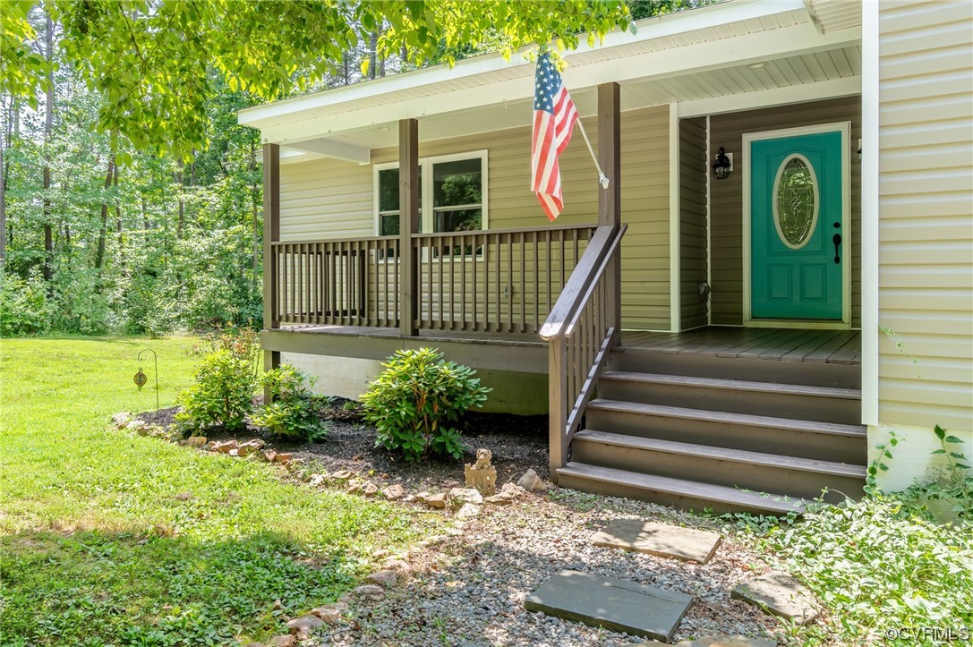 3928 Whitehall Road Sandy Hook, VA 23153 - Photo 2 of 33 a view of a house with a small yard plants and large tree