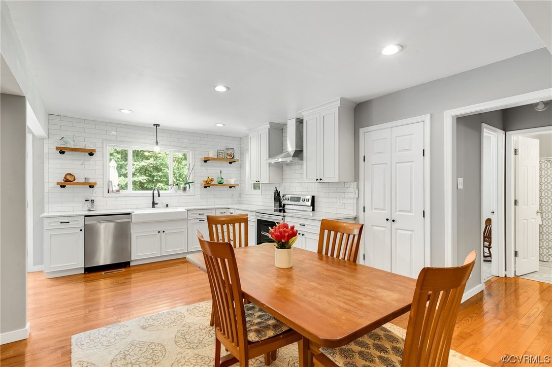 3928 Whitehall Road Sandy Hook, VA 23153 - Photo 10 of 33 a kitchen with stainless steel appliances granite countertop a stove a sink a dining table and chairs