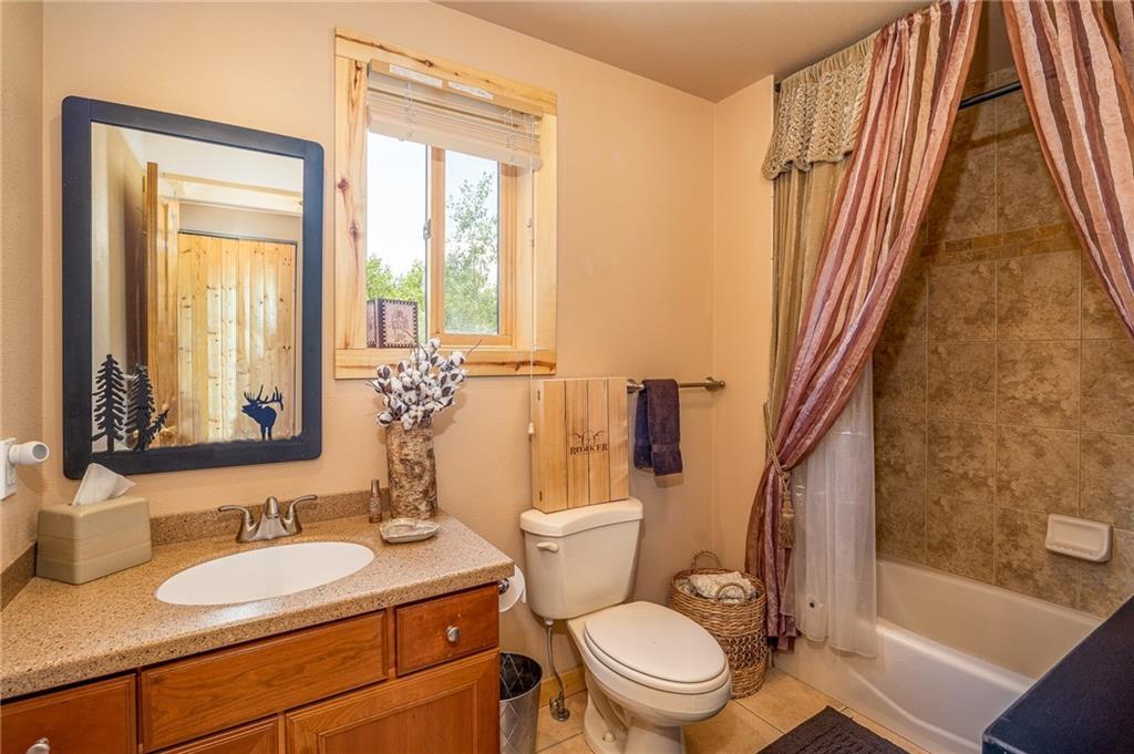 177 East Longbow Drive Como, CO 80456 - Photo 12 of 27 a bathroom with a granite countertop sink toilet and shower