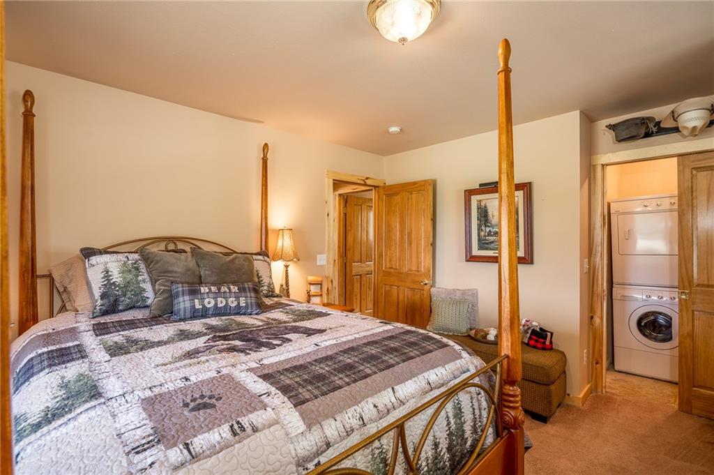 177 East Longbow Drive Como, CO 80456 - Photo 14 of 27 a bedroom with a bed and a chandelier