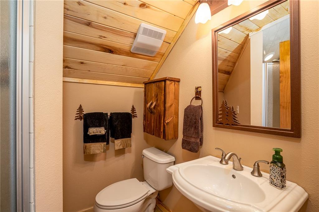 177 East Longbow Drive Como, CO 80456 - Photo 15 of 27 a bathroom with a toilet a sink and a mirror