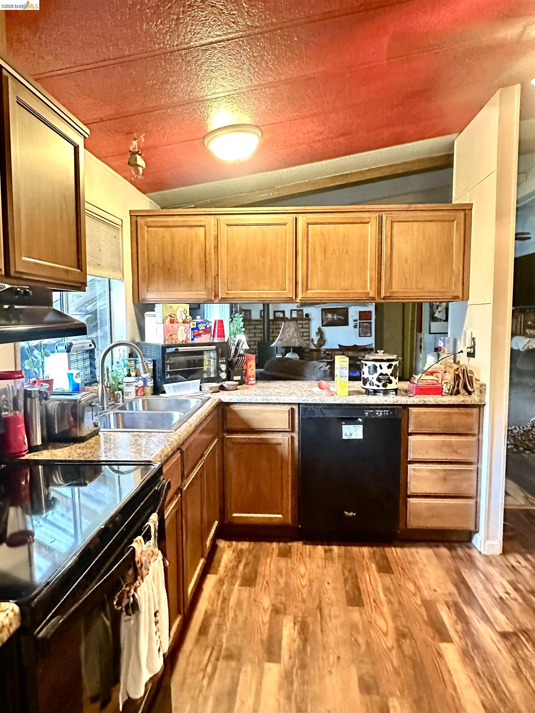 11761 Essen Lane Sonora, CA 95370 - Photo 11 of 20 a kitchen with stainless steel appliances kitchen island granite countertop a refrigerator and a stove
