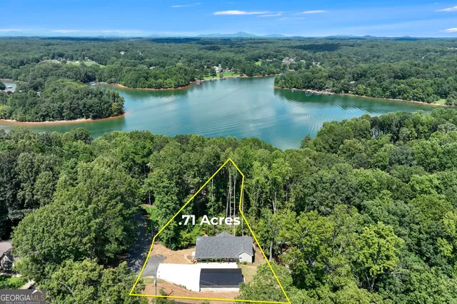 an aerial view of a house with a lake view