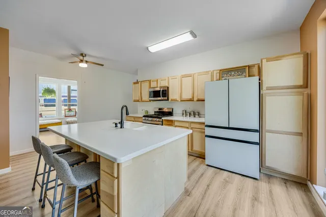 a kitchen with stainless steel appliances a refrigerator stove microwave and cabinets