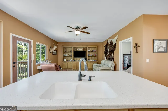 a large bedroom with a large bed and a chandelier