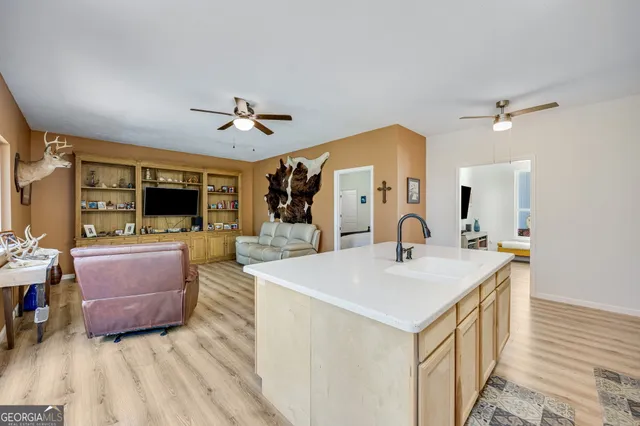 a view of kitchen with sink and refrigerator