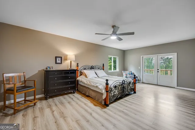 a spacious bedroom with a bed and a chandelier