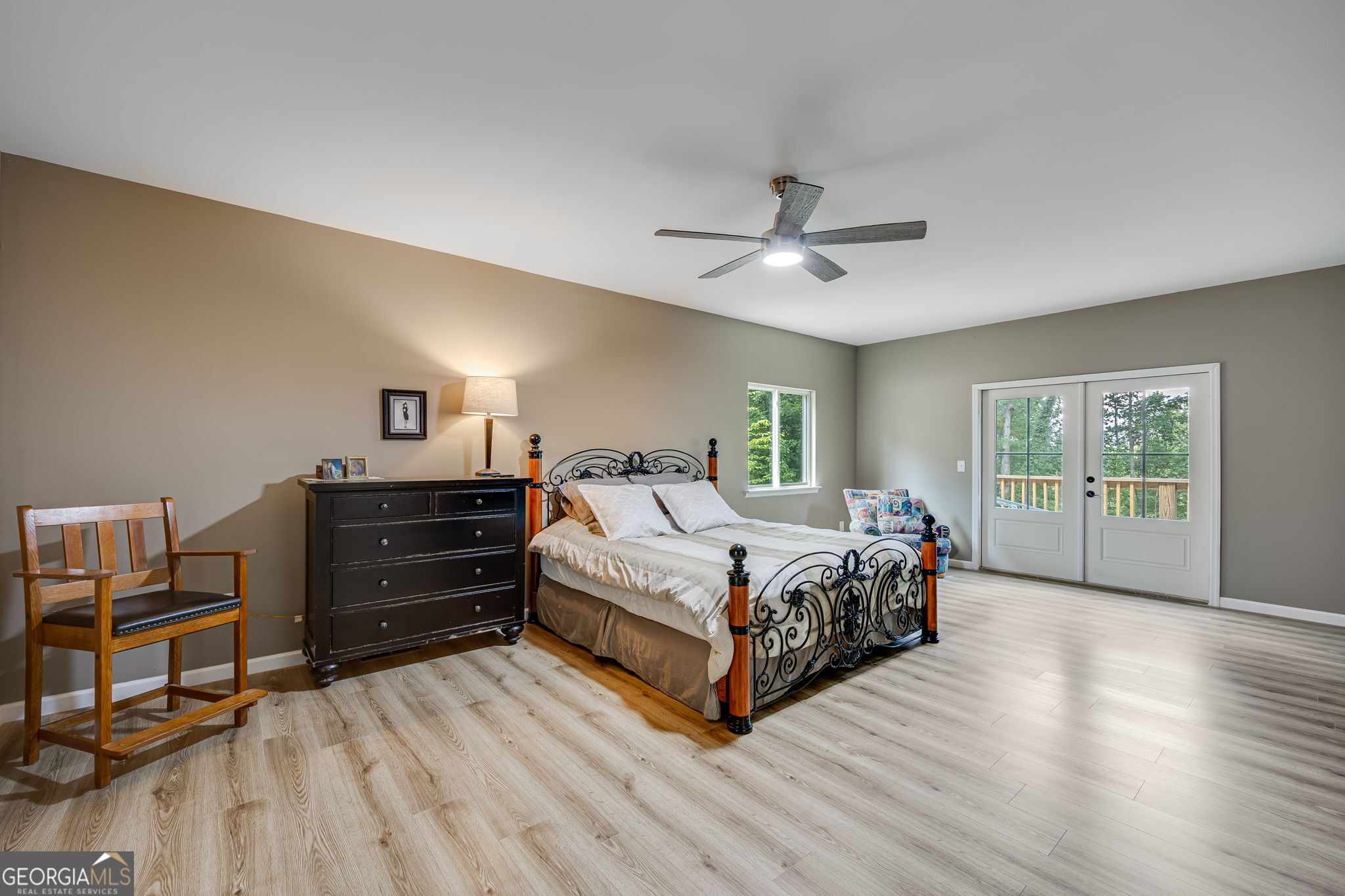 3114 Lake Ranch Drive Gainesville, GA 30506 - Photo 19 of 58 a spacious bedroom with a bed and a chandelier