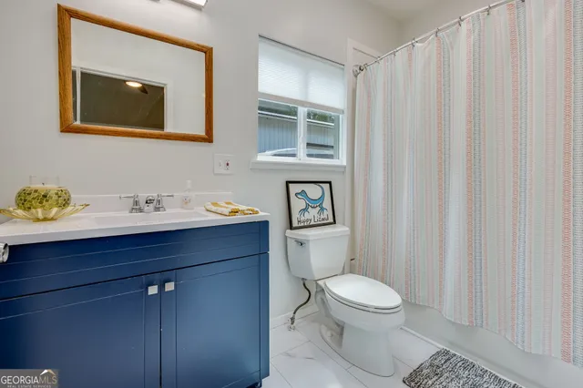 a bathroom with a toilet a sink and a mirror