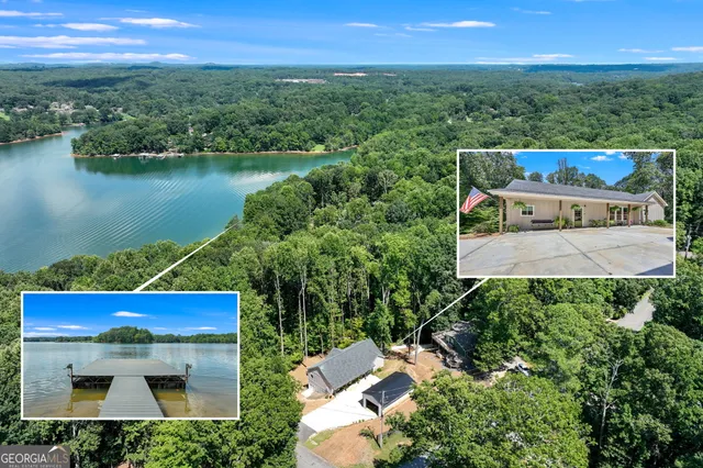 an aerial view of a house with a yard and lake view