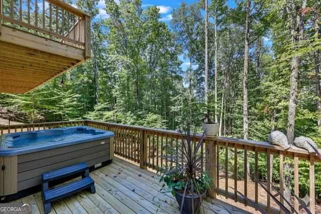a room with lots of white furniture and a chandelier