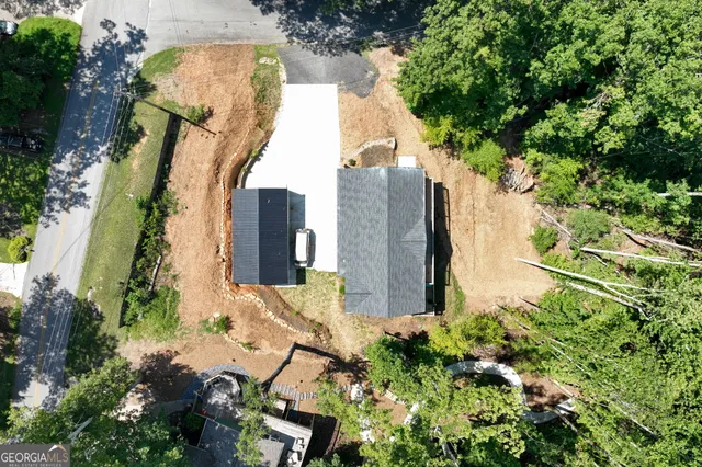 a view of a yard with plants and tree