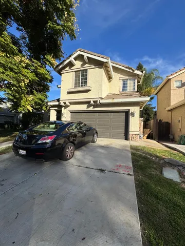 a view of a car park in front of house