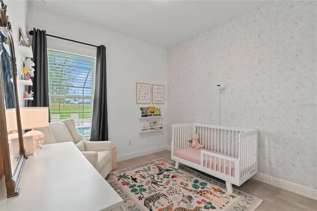 a room with furniture pool table flat screen tv and windows