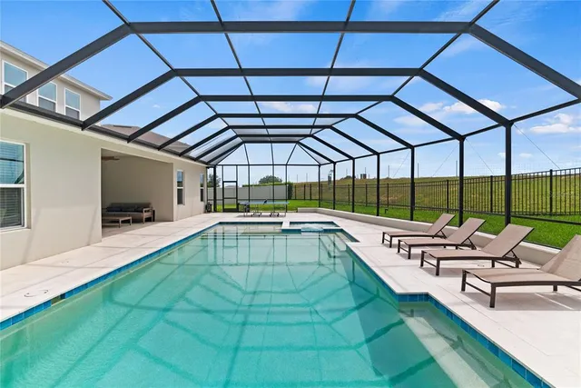 an aerial view of a house with a garden and lake view