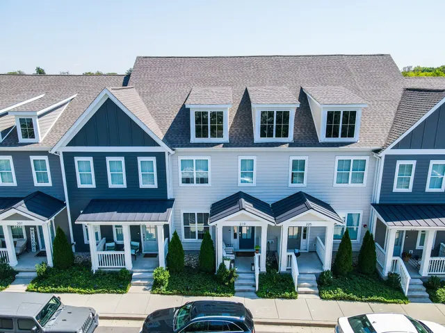 a front view of a residential apartment building with a yard