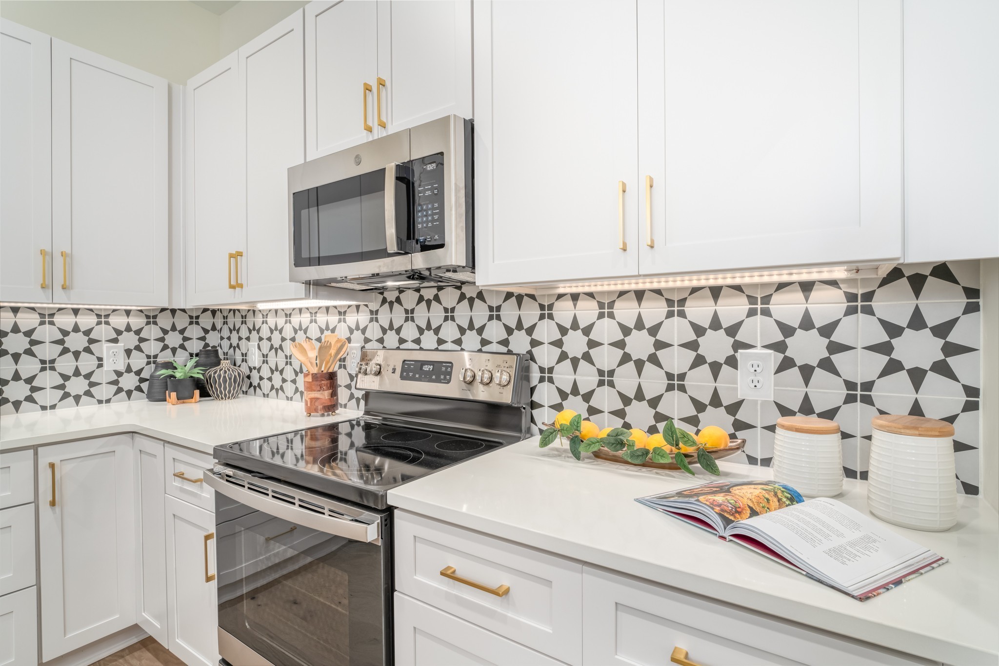 213 Ribbon Lane Franklin, TN 37064 - Photo 11 of 33 a kitchen with a stove a sink and a microwave