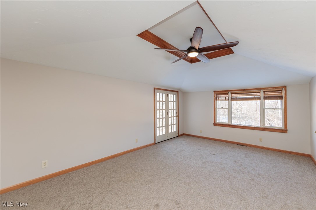 8124 Hartman Road Wadsworth, OH 44281 - Photo 48 of 50 Carpeted spare room with french doors, ceiling fan, and lofted ceiling