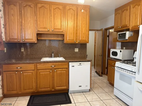 a kitchen with stainless steel appliances granite countertop a refrigerator stove and sink