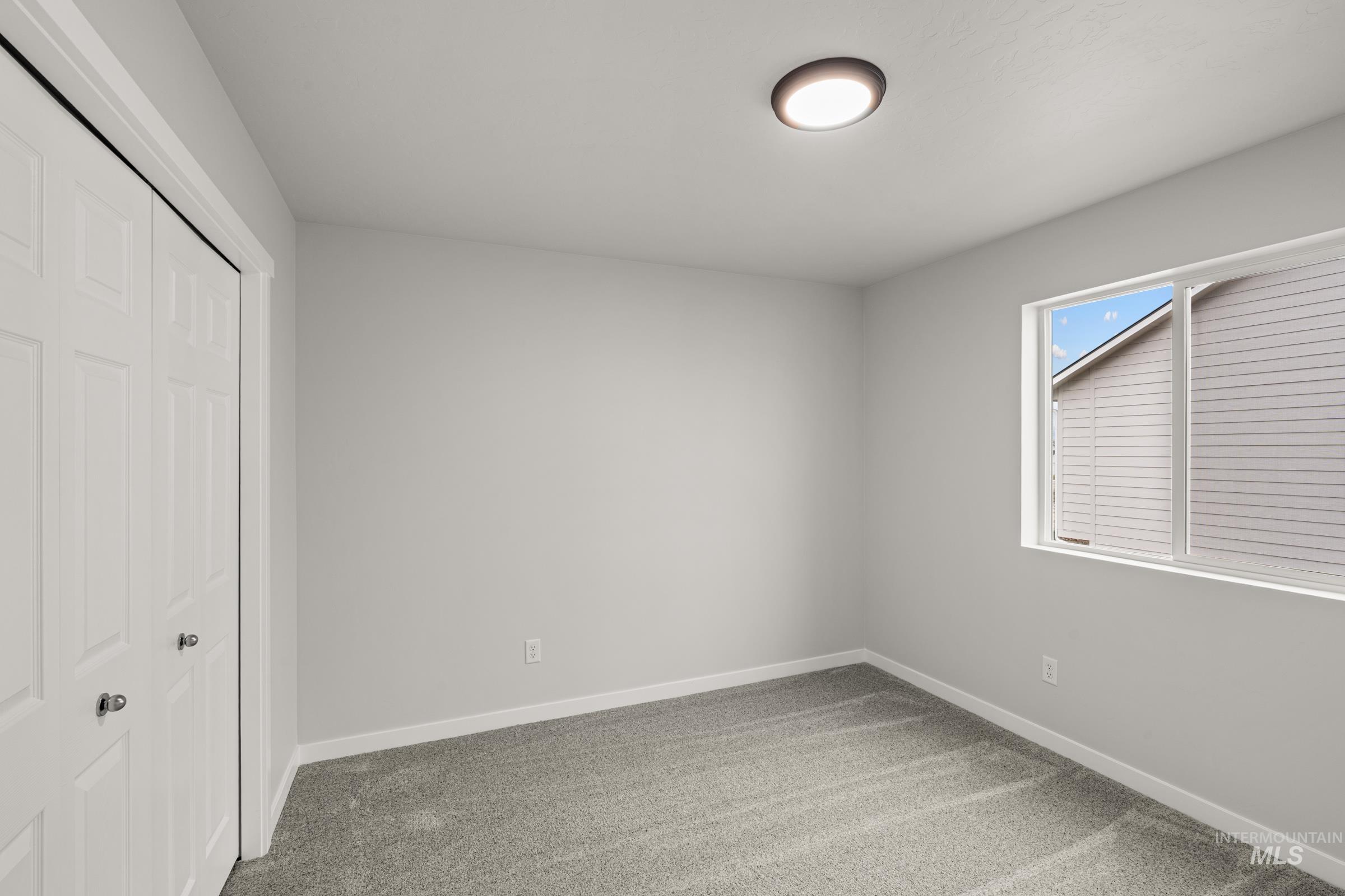 13693 Redway Court Caldwell, ID 83607 - Photo 18 of 25 Unfurnished bedroom featuring a closet and light carpet