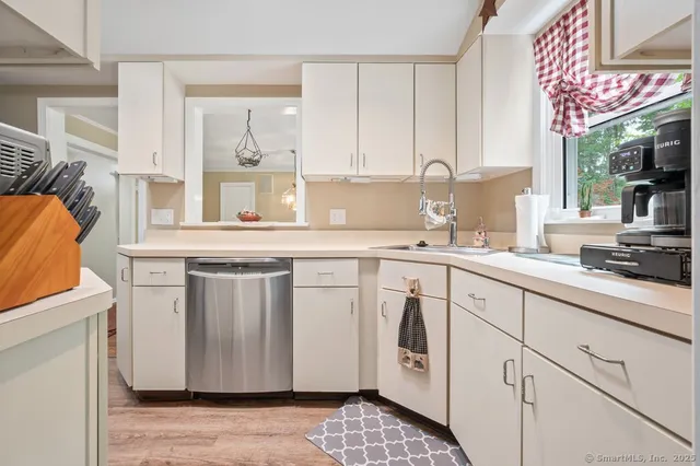 a kitchen with stainless steel appliances granite countertop a sink a stove and a microwave