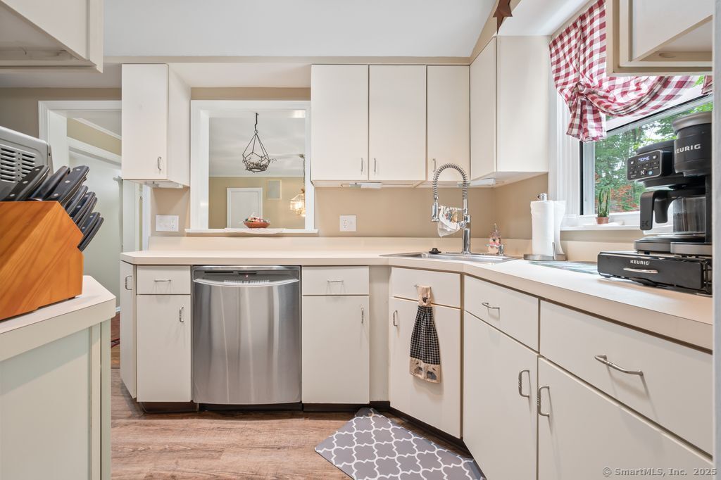 255 Dibble Hill Road Cornwall, CT 06796 - Photo 11 of 40 a kitchen with stainless steel appliances granite countertop a sink a stove and a microwave