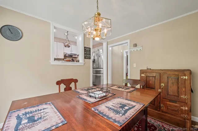 a living room with a table and chairs