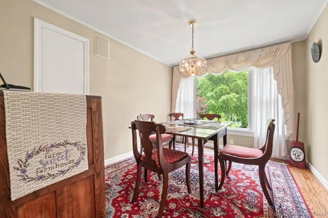 a view of a dining room with furniture and a window