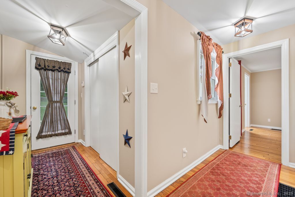 255 Dibble Hill Road Cornwall, CT 06796 - Photo 16 of 40 a view of hallway with walk in closet and wooden floor