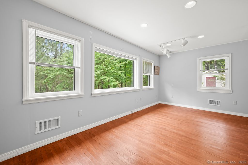 255 Dibble Hill Road Cornwall, CT 06796 - Photo 17 of 40 a view of an empty room with wooden floor and a window