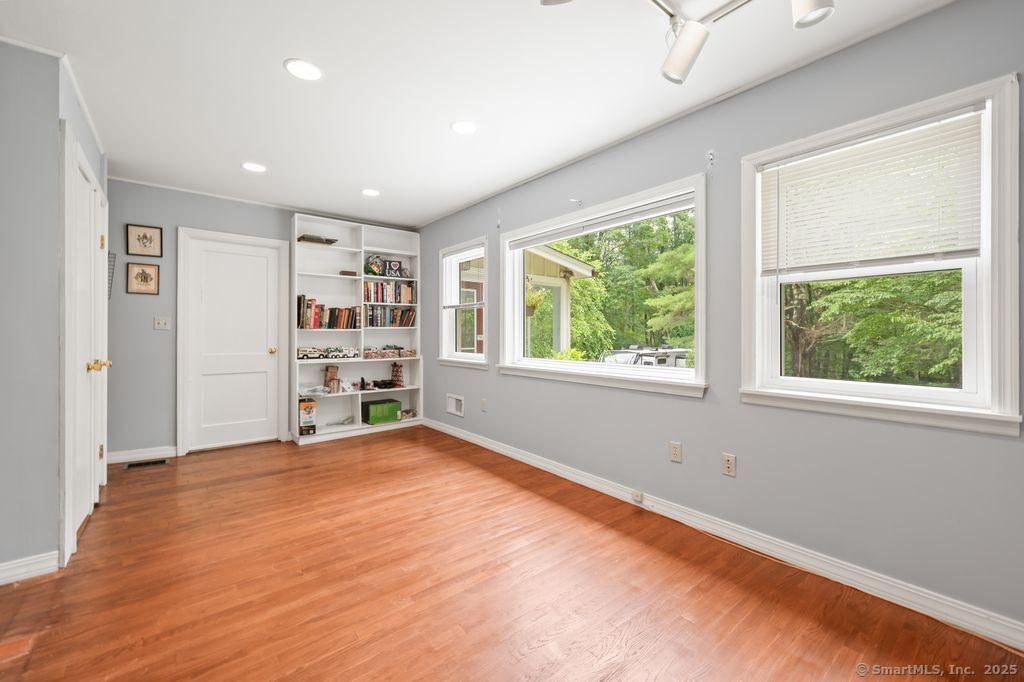 255 Dibble Hill Road Cornwall, CT 06796 - Photo 18 of 40 a view of an empty room with a window and a kitchen