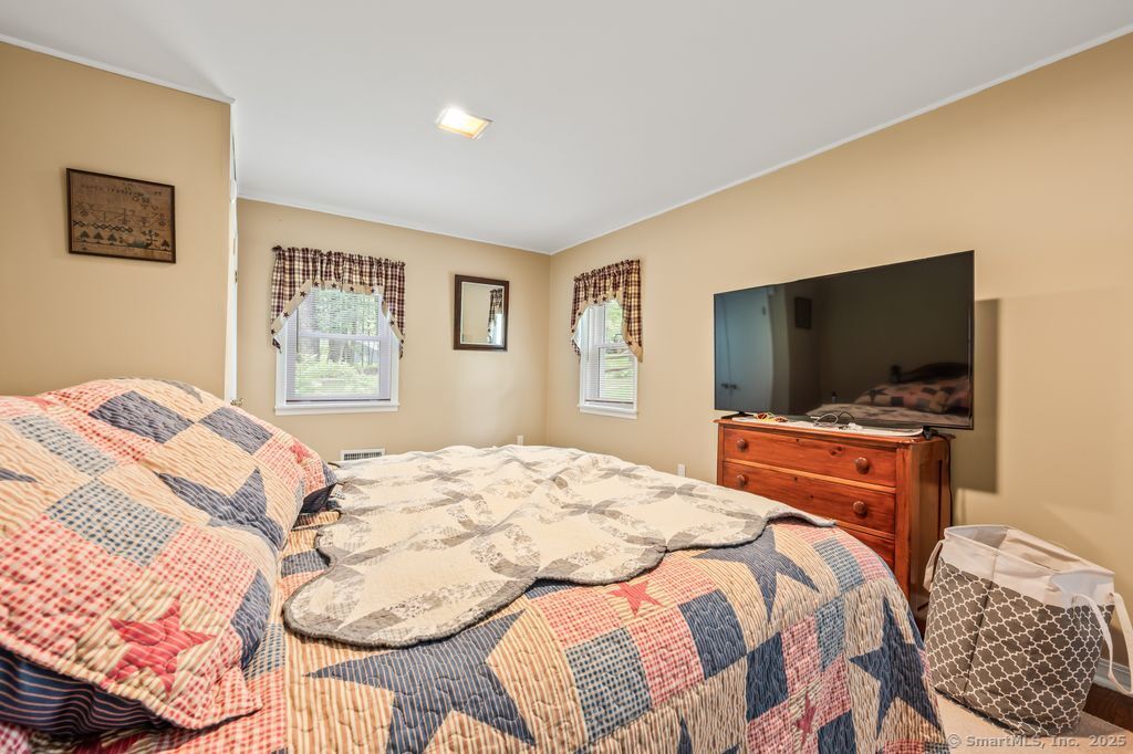 255 Dibble Hill Road Cornwall, CT 06796 - Photo 20 of 40 a bedroom with a bed and a flat screen tv