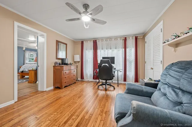 a view of a livingroom with workspace and a couch