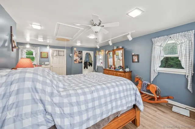 a bed room with a bed mirror and a window