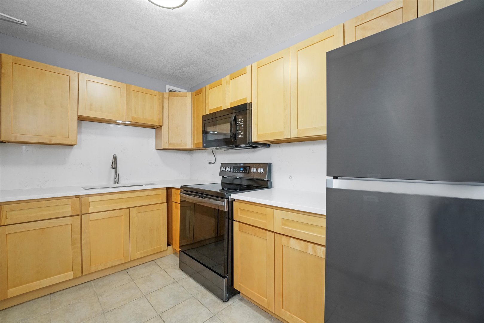 6301 North Sheridan Road, Unit 9A Chicago, IL 60660 - Photo 10 of 23 a kitchen with a sink cabinets and a window