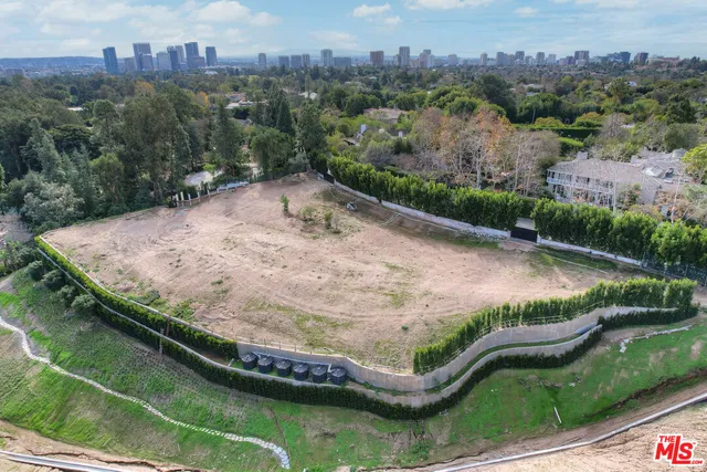 an aerial view of a house with a yard and lake view