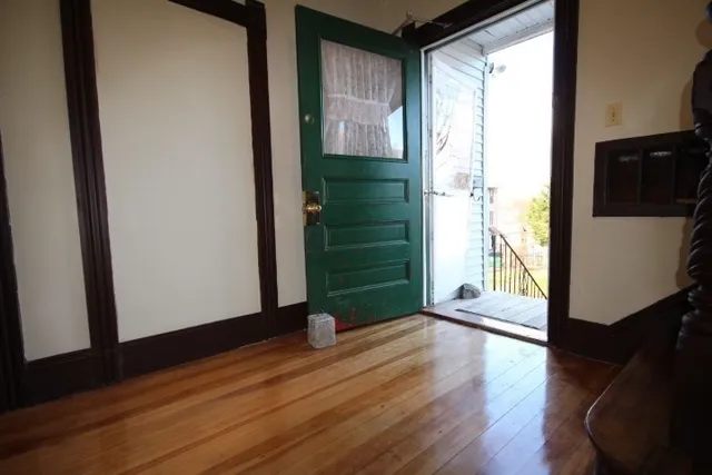 a view of an entryway with wooden floor